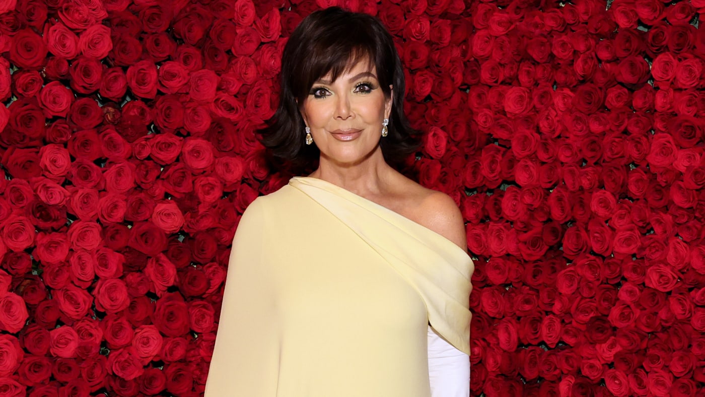 Kris Jenner is pictured in front of a bunch of flowers