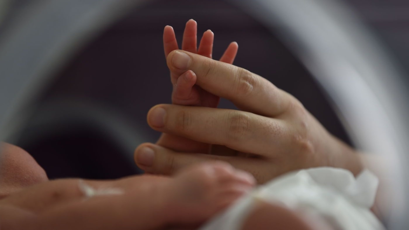 The hand of a nurse in the neonatology department at Jiangning Hospital in Nanjing