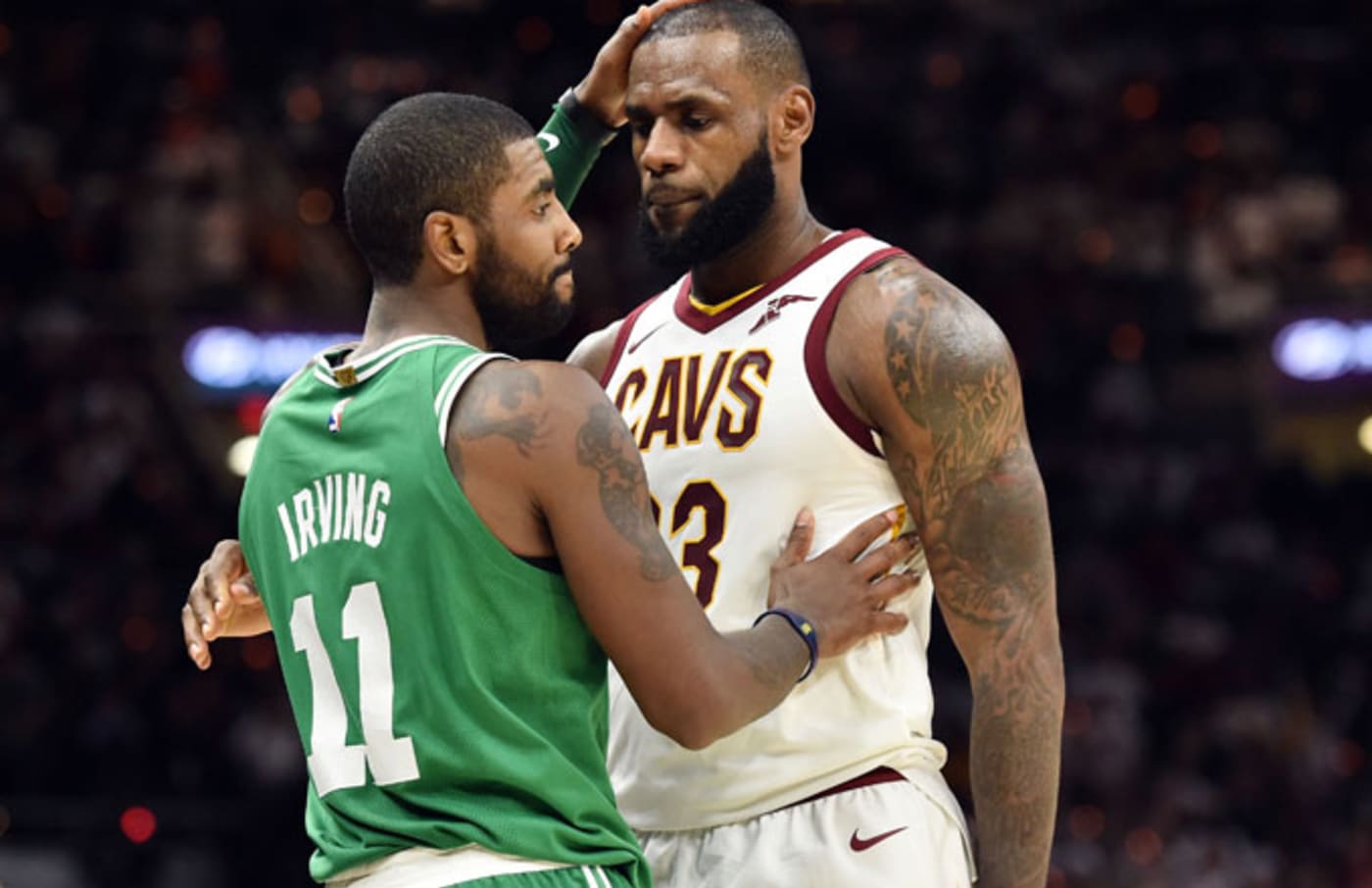 Kyrie Irving and LeBron James embrace on opening night.