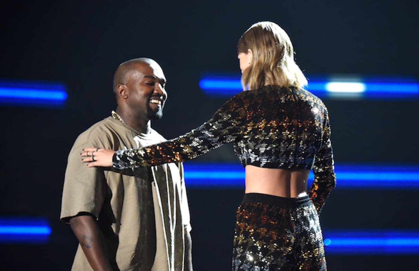 Kanye West and Taylor Swift greet one another.