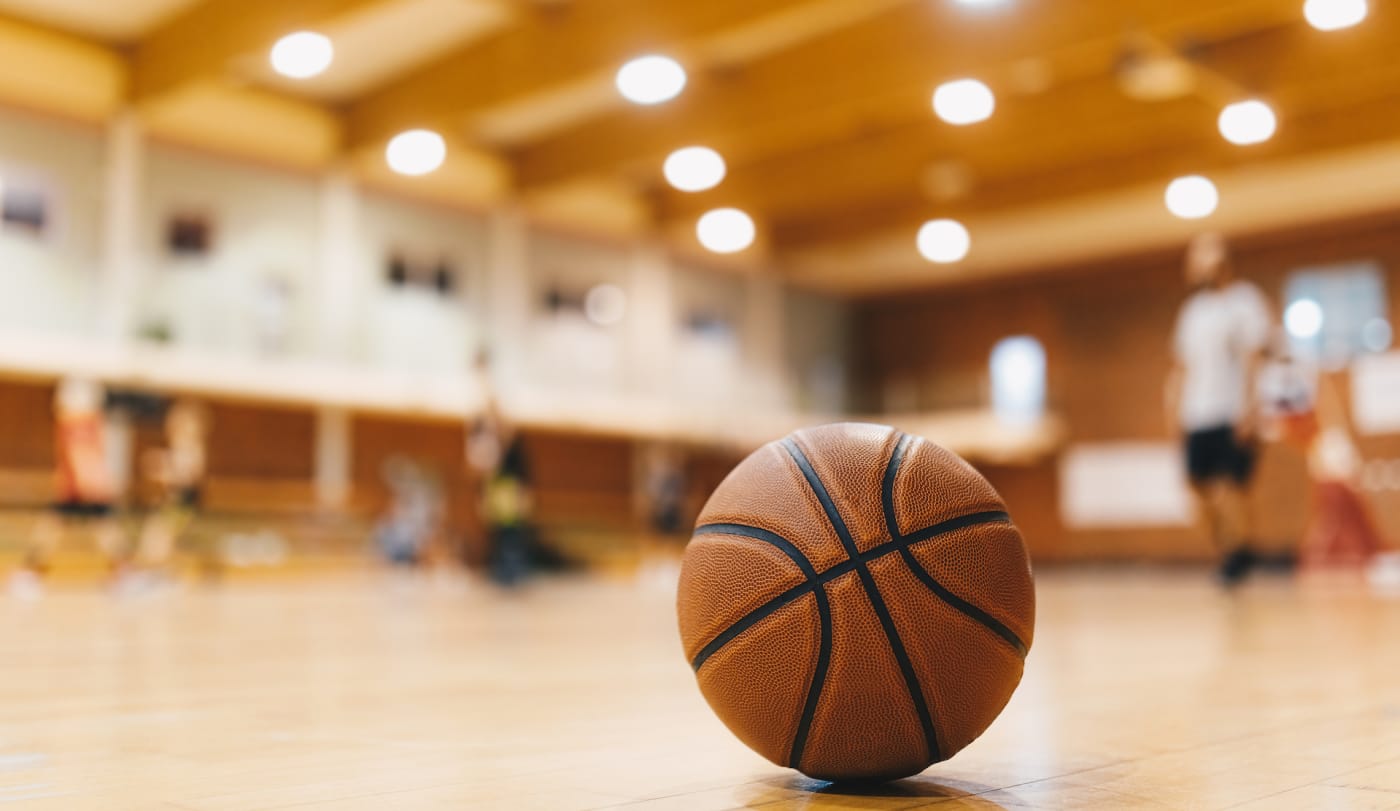 A basketball as seen on a high school basketball court