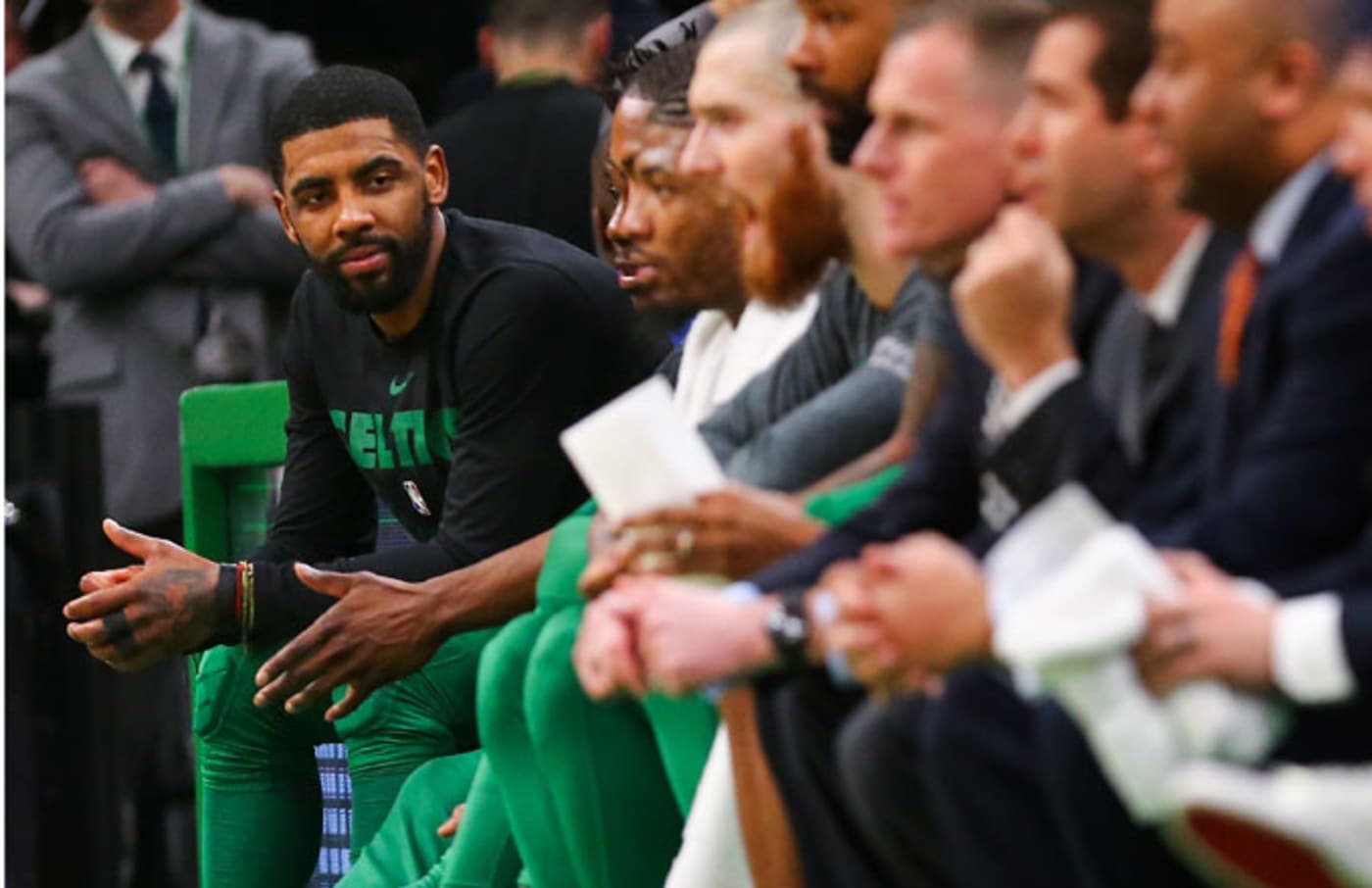 Kyrie Irving sits on the Celtics' bench