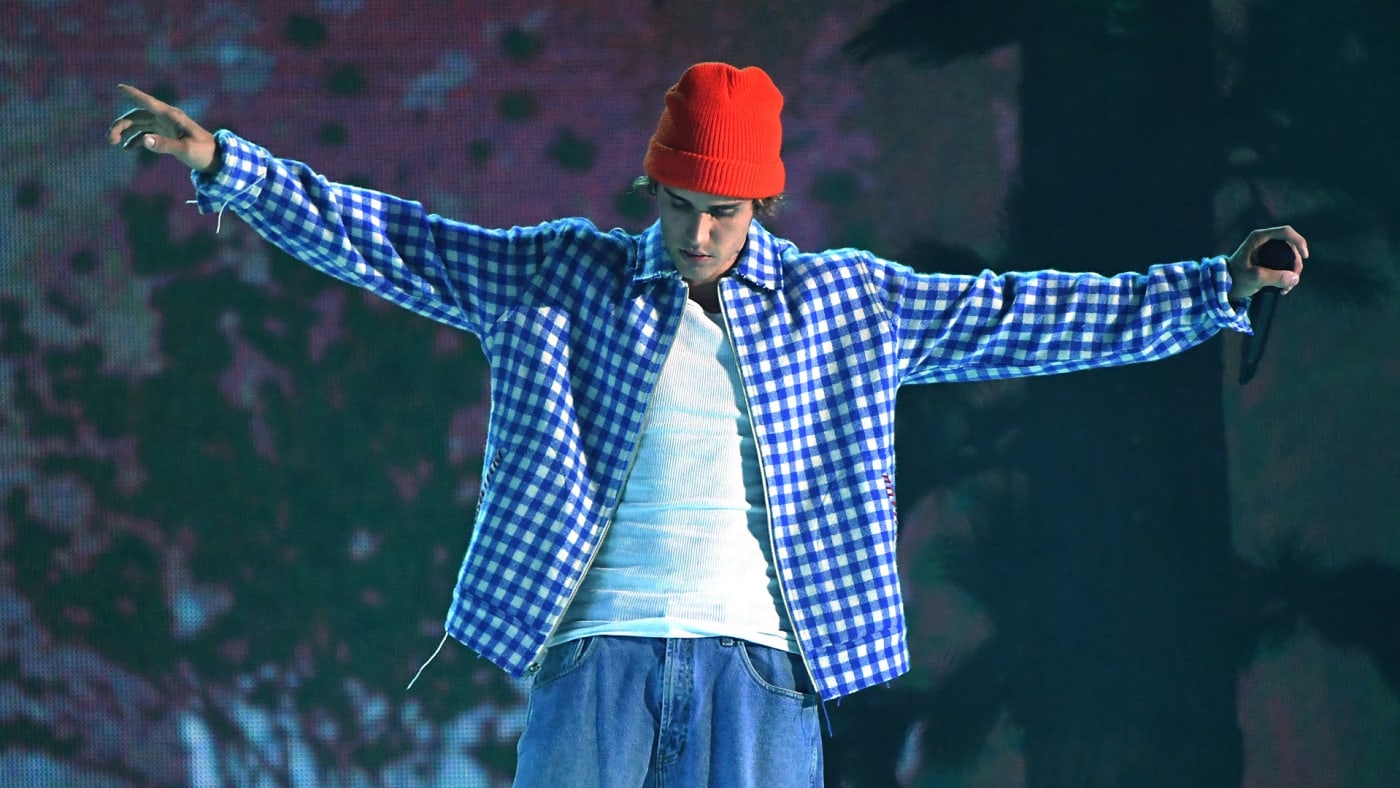 Justin Bieber posing in a red toque