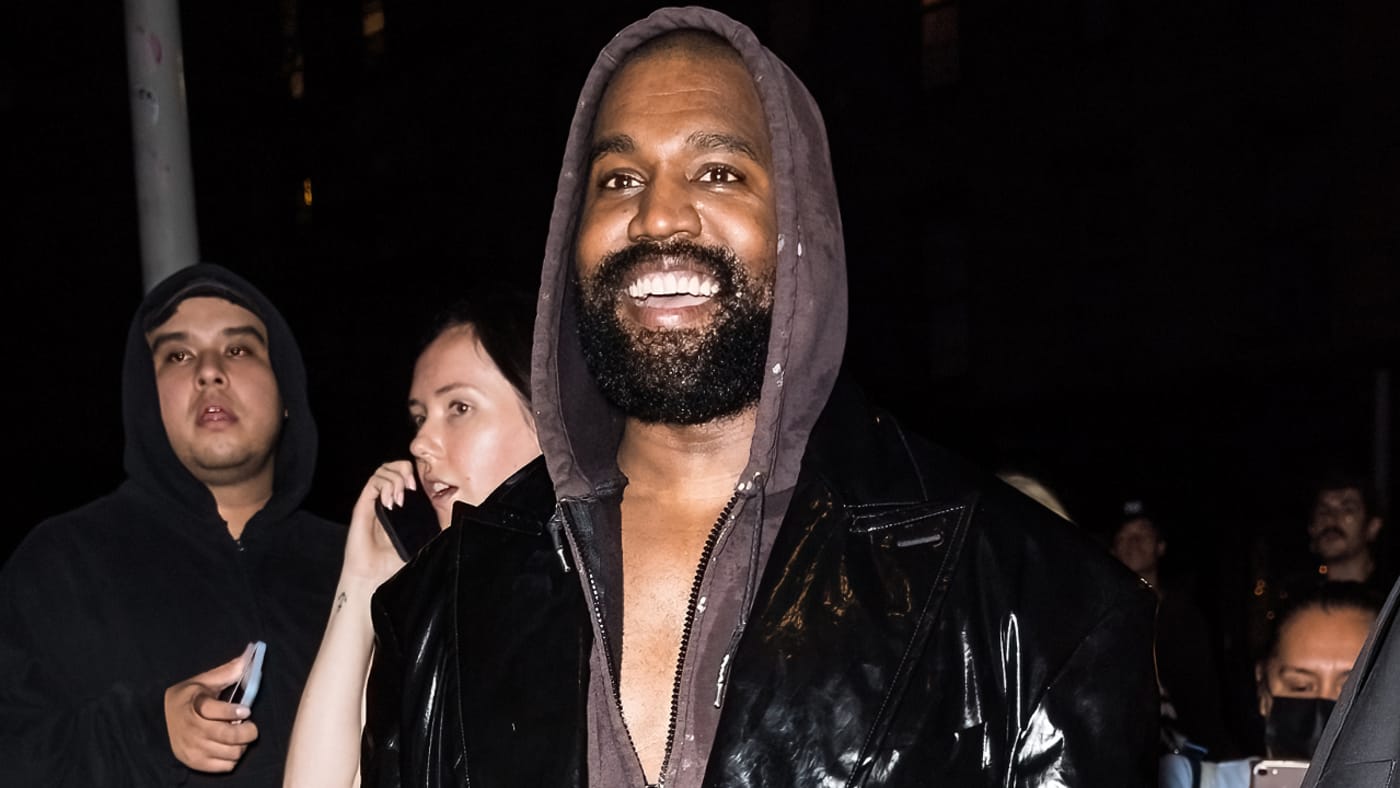 Ye is pictured wearing a hoodie under a jacket