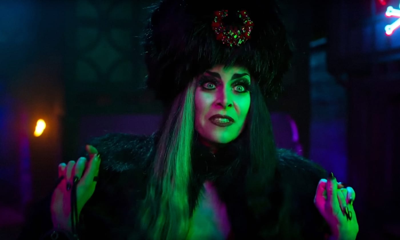 A woman dressed in a munsters halloween costume.