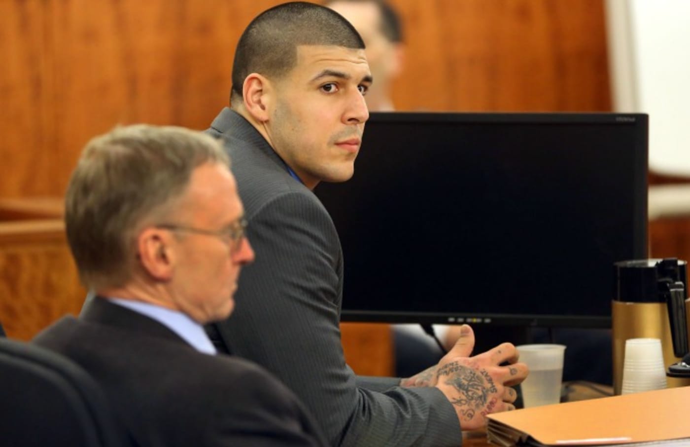 Aaron Hernandez sits in a courtroom.