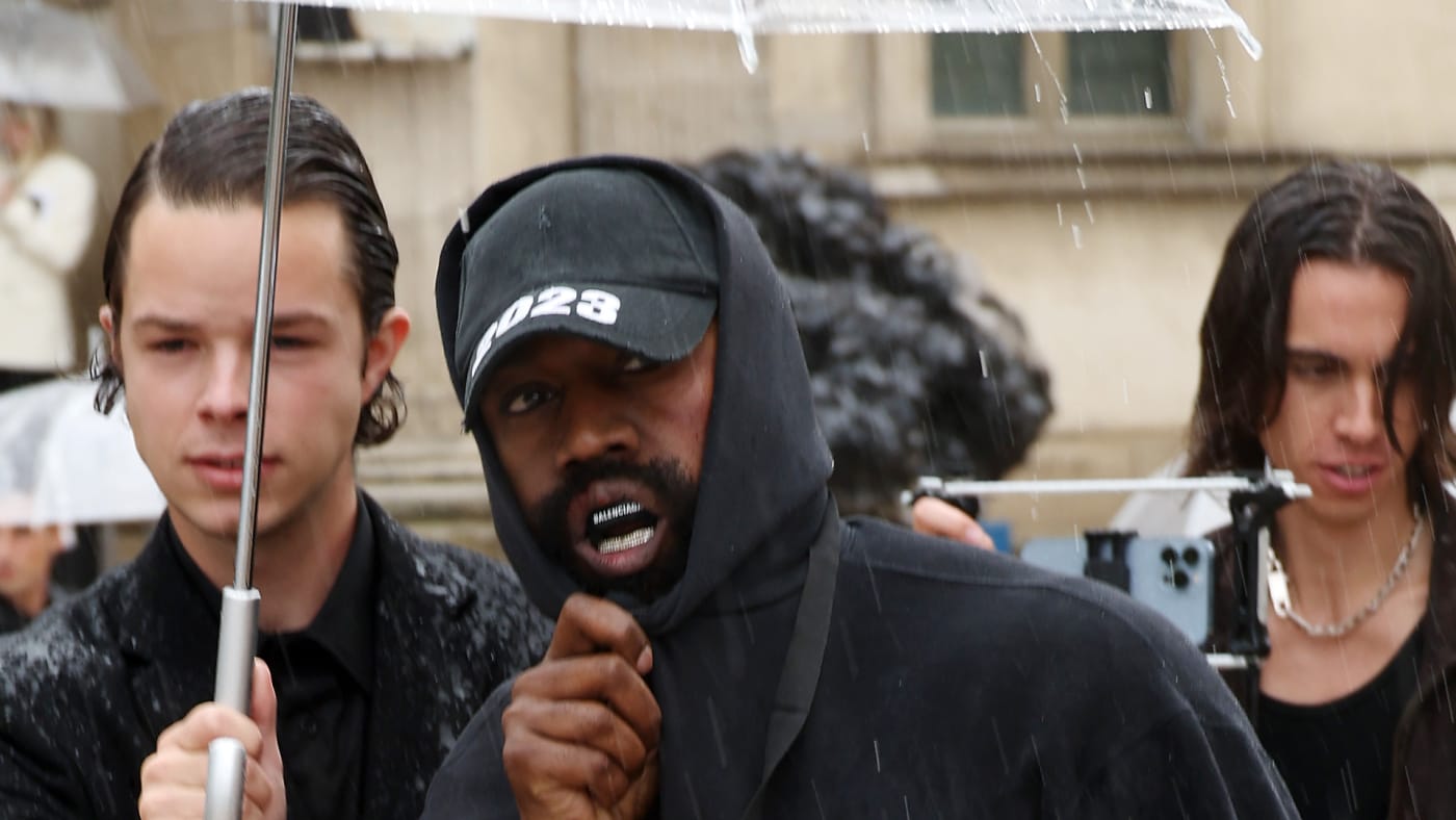 Ye is seen having an umbrella held over him