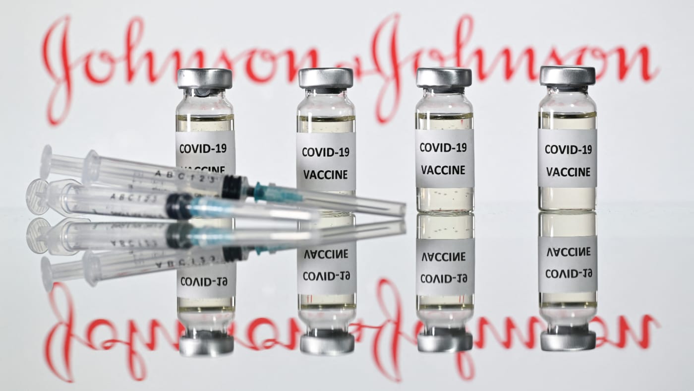 Illustration shows vials with Covid-19 Vaccine stickers with Johnson & Johnson logo.