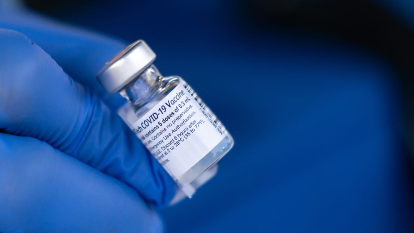A nurse shows off a vial of the Pfizer-BioNTech COVID-19 vaccine.