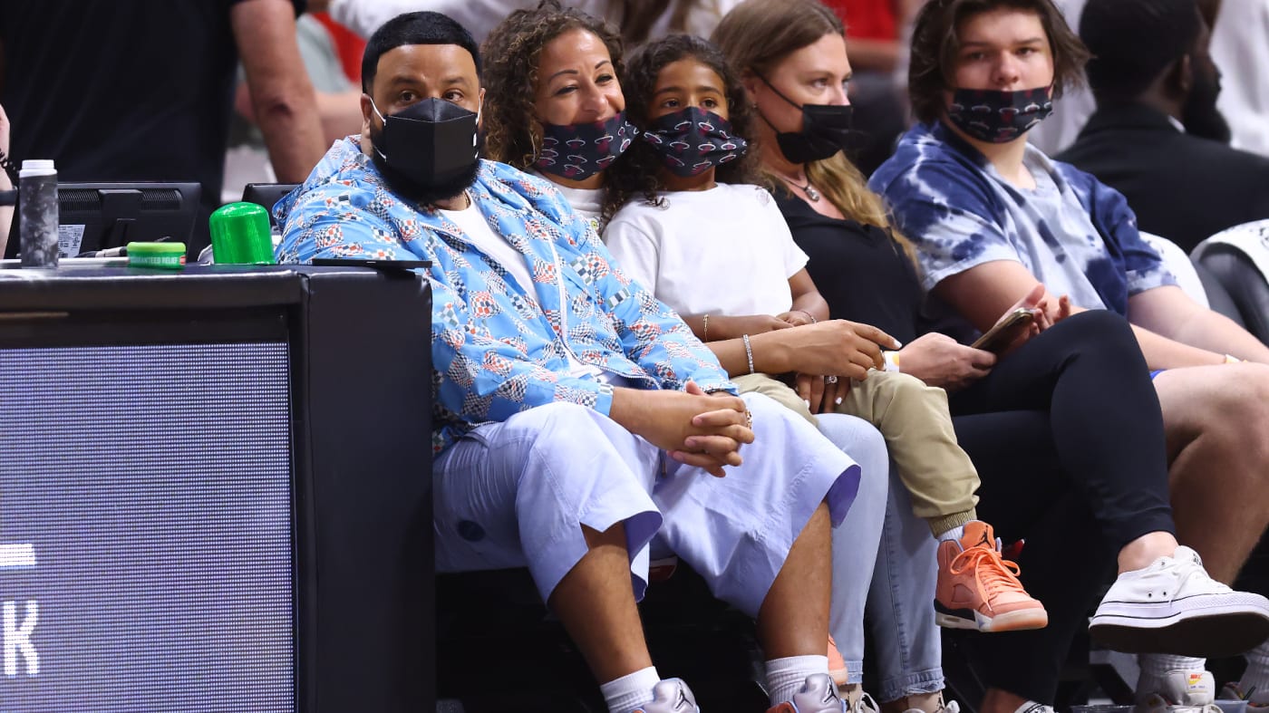 DJ Khaled, his son, Asahd Khaled, and his wife, Nicole Tuck, look on courtside.