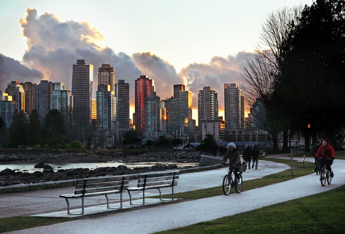 People biking during sunset in the city of Vancouver.