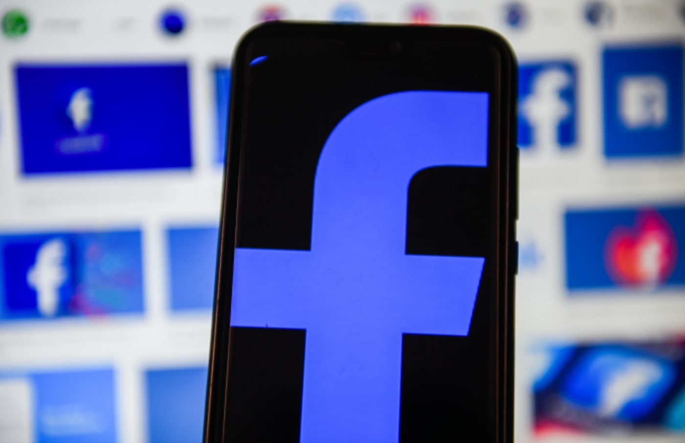 In this photo illustration a Facebook logo displayed on a smartphone