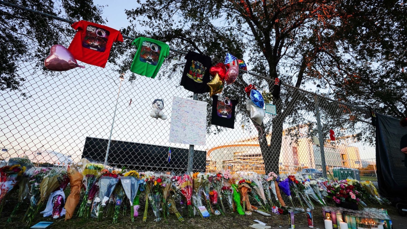 Candles, flowers and letters are placed at a memorial outside of the canceled Astroworld festival