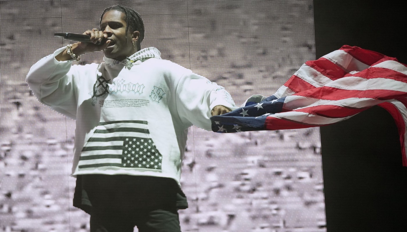 Rocky onstage with flag in hand