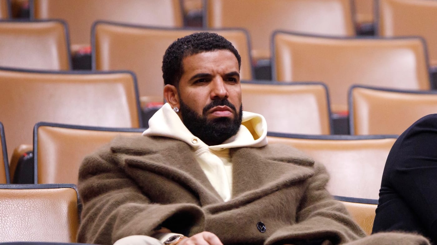 Drake sits with Toronto Raptors president Masai Ujiri