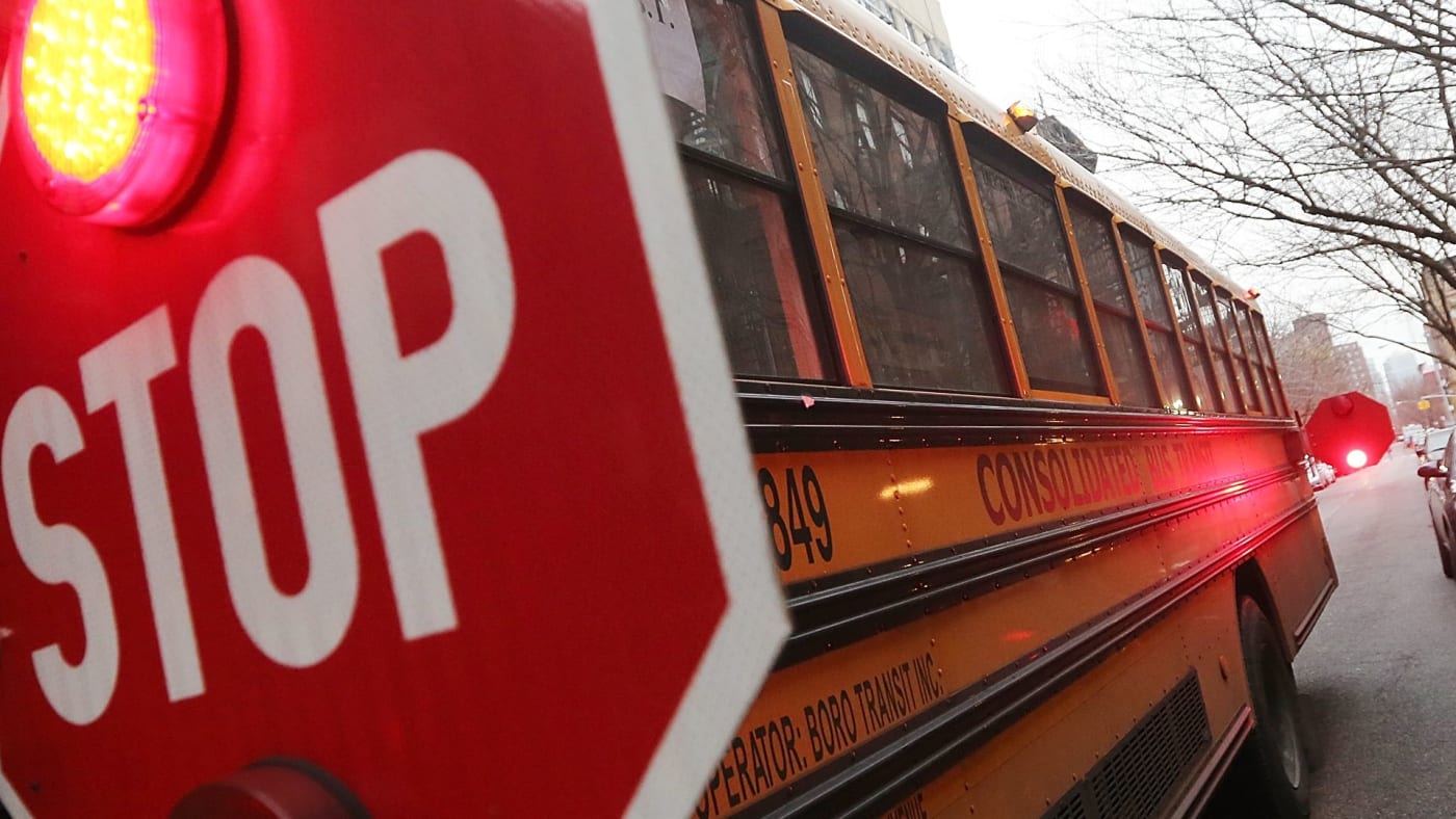 A school bus is stopped while picking up a student in Manhattan