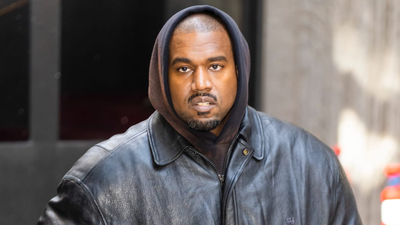 Ye is seen wearing a hoodie and a jacket