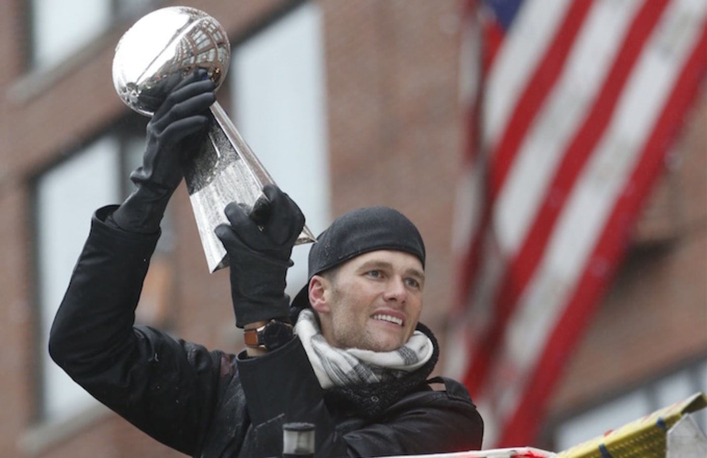 Tom Brady holds Super Bowl trophy at Patriots' championship parade.