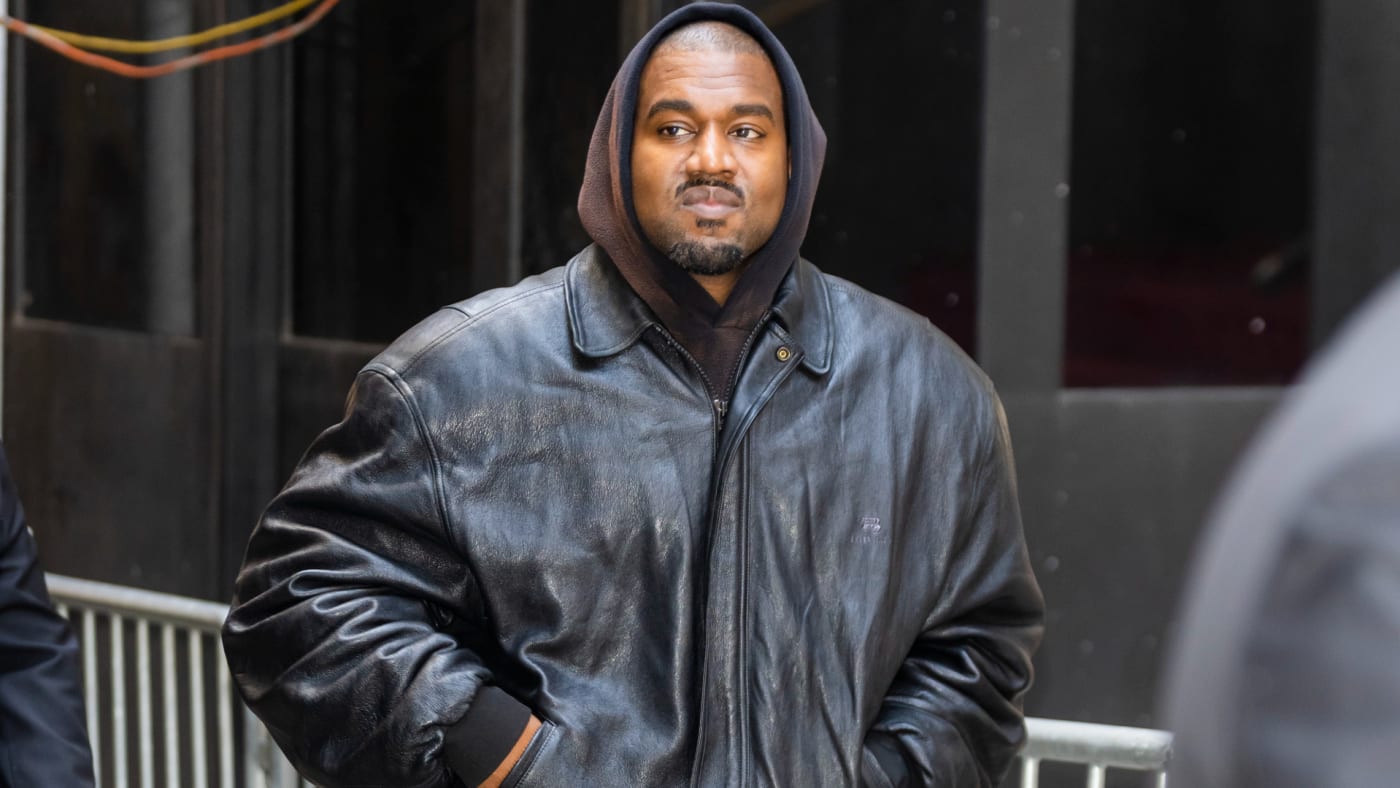 Ye is seen walking while wearing a leather jacket