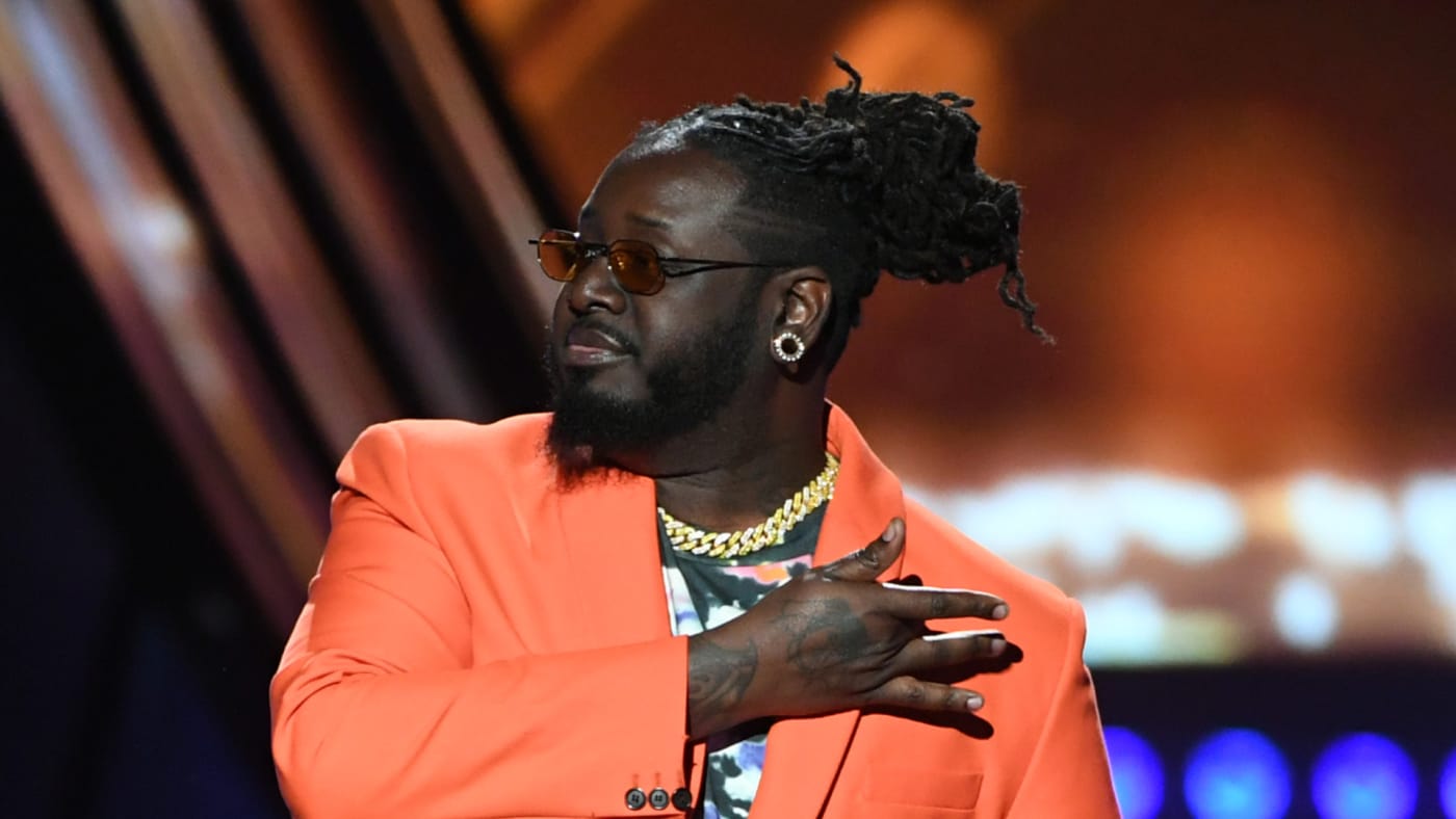 T-Pain speaks on stage at the 2019 iHeartRadio Music Awards.