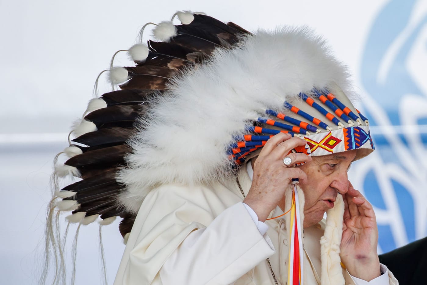 Pope Francis wears a traditional headdress that was gifted to him following his apology during his visit to Maskwacis, Canada