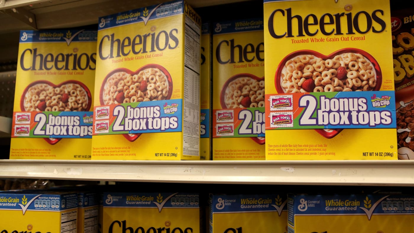 Boxes of Cheerios cereal sit on the shelf at a grocery store.