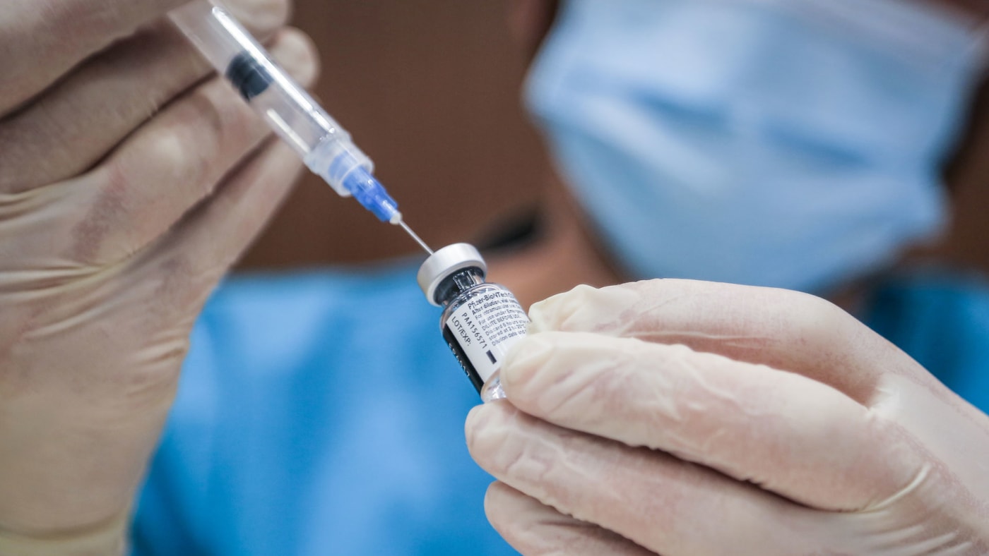 A health worker prepares a dose of Pfizer/BioNTech coronavirus (COVID 19) vaccine.