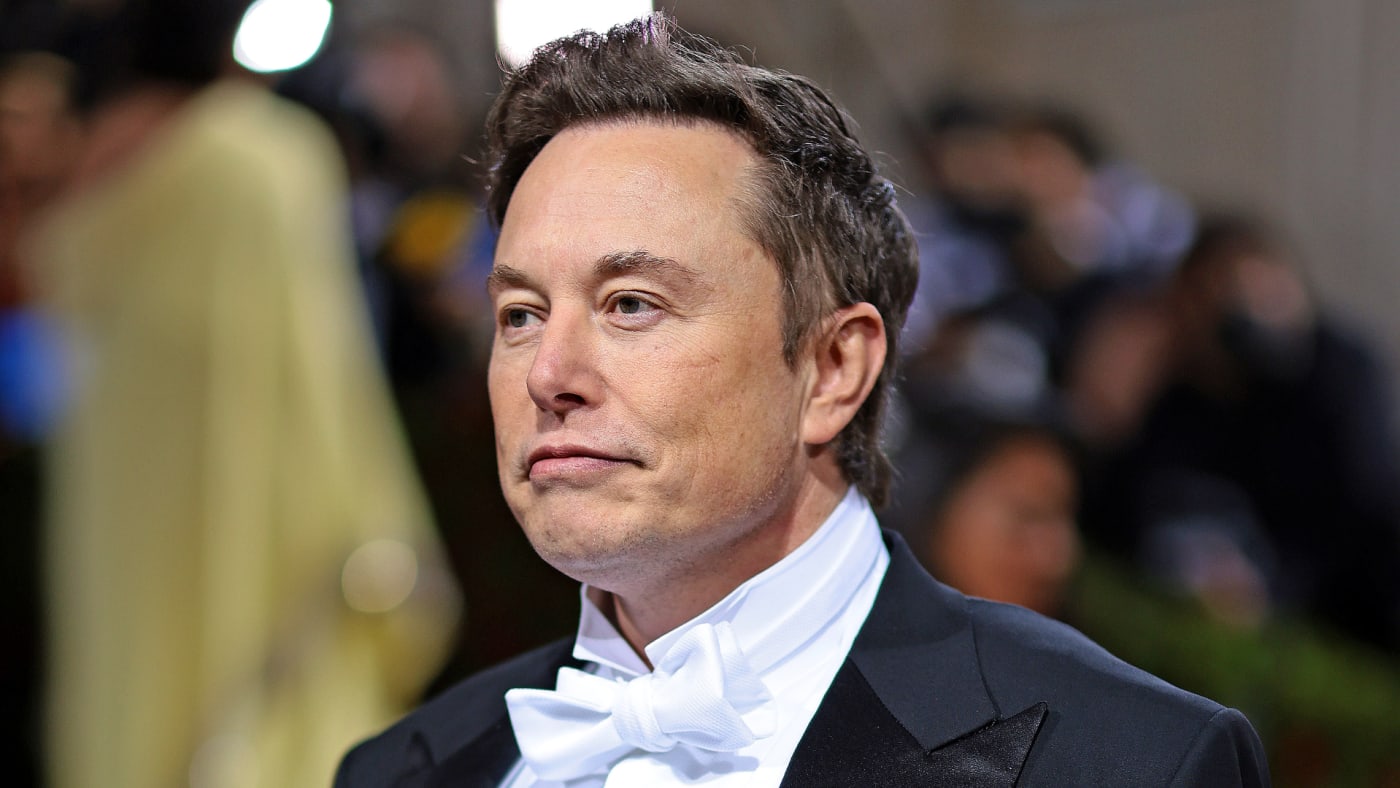 Elon Musk is pictured wearing a suit