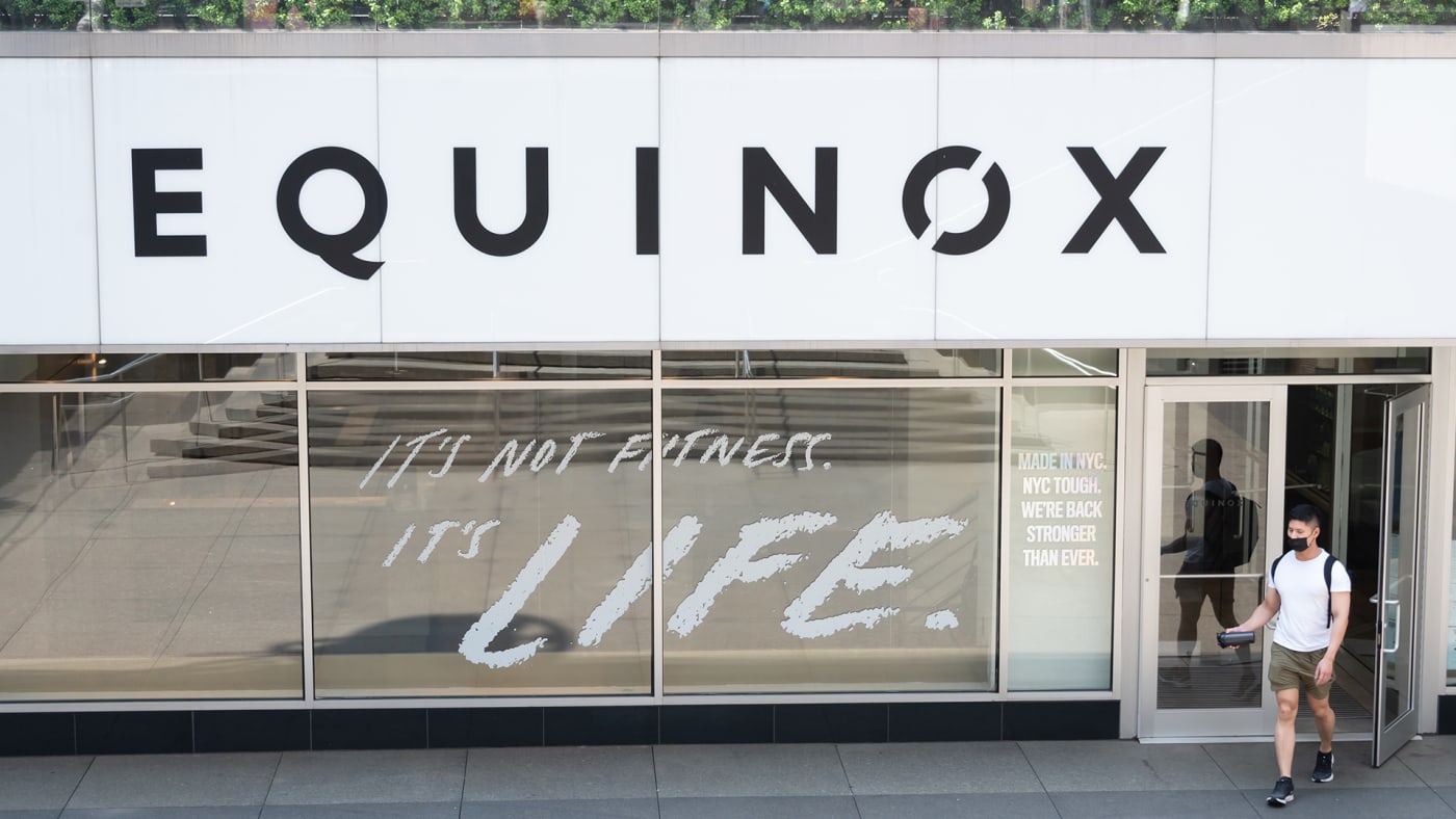 A person exits Equinox gym in Times Square on May 26, 2021 in New York City