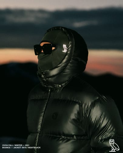 Model in black shiny puffer jacket  - OVO Drake