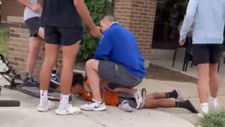 Chicago officer pins child to ground and accuses him of stealing his son's bike.