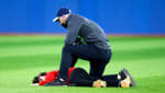A kid being tackled after running onto the field at a Toronto Blue Jays game