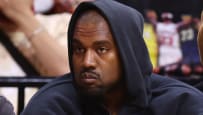 Kanye at the game staring ahead